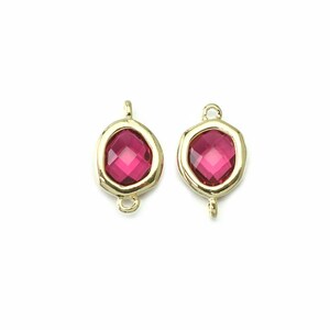 May include: Two gold-toned metal connector charms with a red faceted gemstone in the center. The charms have a loop on each side for attaching to jewelry.
