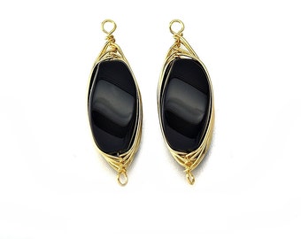 May include: A pair of black oval gemstone earrings with gold wire wrapping and a gold loop for hanging.