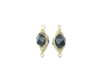 May include: A pair of gold wire wrapped earrings with black gemstone accents.