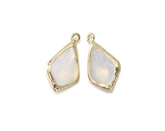 May include: Two gold-toned pendant charms with a white, opaque, diamond-shaped stone.