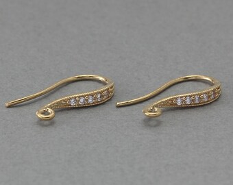 May include: A pair of gold-tone earring hooks with a row of clear cubic zirconia stones.