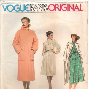 May include: Vintage Vogue Paris Original sewing pattern featuring Christian Dior designs. The pattern includes illustrations of three different outfits: a long peach coat, a cream-colored dress, and a green polka-dot dress with a white coat.