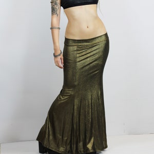 May include: A gold metallic mermaid skirt with a black halter top. The skirt has a fitted bodice and a flowing mermaid tail.