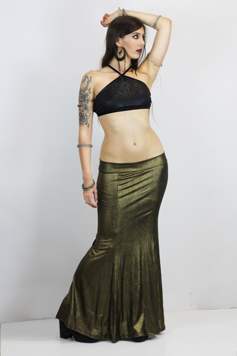 May include: A gold metallic mermaid skirt with a black halter top. The skirt has a fitted bodice and a flowing mermaid tail.