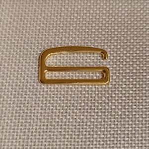 May include: Gold metal slider buckle with two loops.