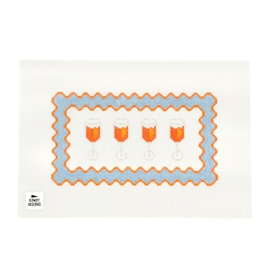 May include: A needlepoint canvas with a blue and orange border featuring four orange glasses with orange liquid inside. The canvas is white with a small logo in the bottom left corner that says "Rowdy Designs".