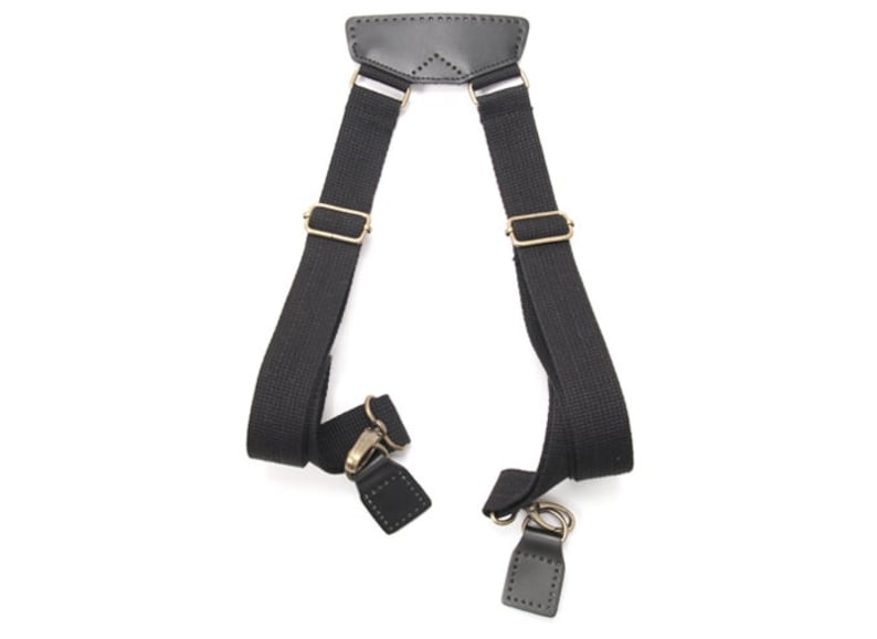 May include: Black canvas shoulder straps with leather accents and brass hardware. The straps are adjustable and have a buckle closure.