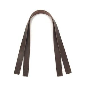 May include: A pair of brown leather straps, stitched together, for a bag or purse.