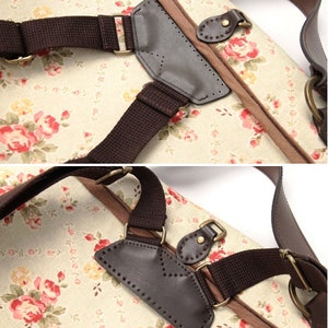 May include: A close-up of a brown leather strap with a floral pattern. The strap is attached to a bag with a brown leather flap. The strap has a buckle and a metal ring.