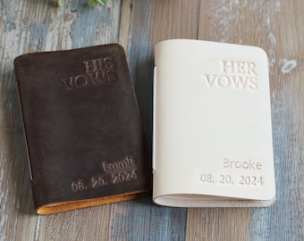 May include: Two leather vow books, one dark brown and one cream. The dark brown book reads "HIS VOWS" and "Emmit 08. 20. 2024". The cream book reads "HER VOWS" and "Brooke 08. 20. 2024".