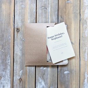 May include: A kraft paper envelope with a white card inside. The card says "Happy birthday, Stephanie!" and has a message about bringing joy and clarity.