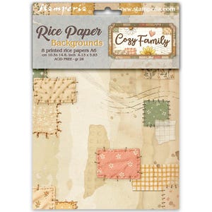 May include: A package of 8 Stamperia Rice Paper Backgrounds titled Cozy Family. The packaging displays the text Rice Paper Backgrounds, Cozy Family, and dimensions of 10.5 x 14.8 cm or 4.13 x 5.83 inches. The paper features a beige patchwork design.