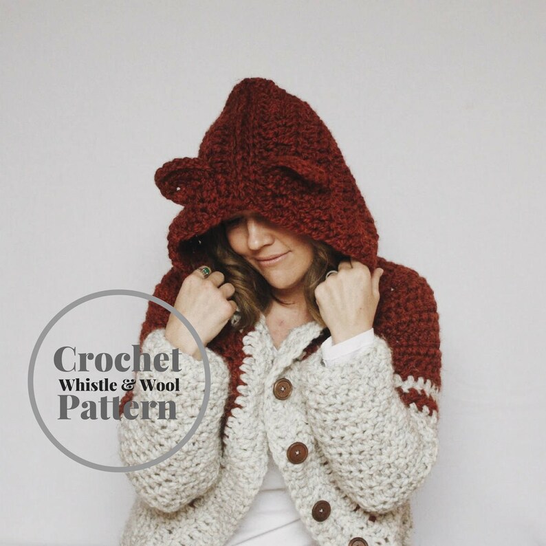 May include: A crochet pattern for a hooded cardigan with a red hood and white and brown body. The pattern is called "Whistle & Wool".