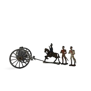 May include: A collection of antique toy soldiers and a cannon. The set features a cannon with two large wheels, a soldier on horseback, and two standing soldiers. The figures are painted in brown, red, and white.