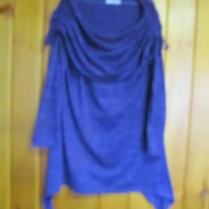 May include: A purple cowl neck sweater with a draped neckline and long sleeves.