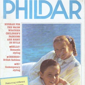 May include: A magazine cover featuring two children wearing knitted sweaters. The magazine is titled "PHILDAR" and features the text "HURRAH FOR THE WARM WEATHER CHILDREN'S FASHIONS ARE RIGHT IN STYLE" and "HELLO! Romantic styling CHEERIO! British fashions HI! Contemporary styling Featuring different blends of yarns on a white background WELCOME! Tropical fashions".