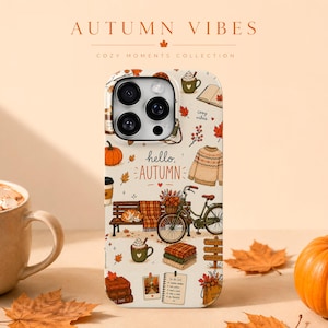 May include: A phone case with a cream background featuring a repeating pattern of autumn-themed illustrations including a bicycle, a park bench, a sweater, pumpkins, mugs, and books. The text "hello, AUTUMN" is printed in the center of the case.