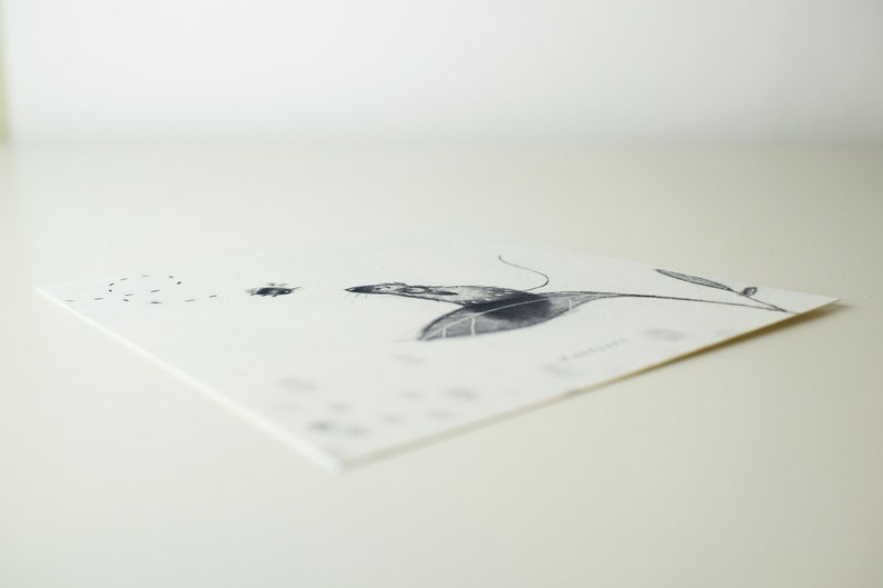 May include: A black and white illustration of a mouse on a leaf with a trail of small dots behind it.