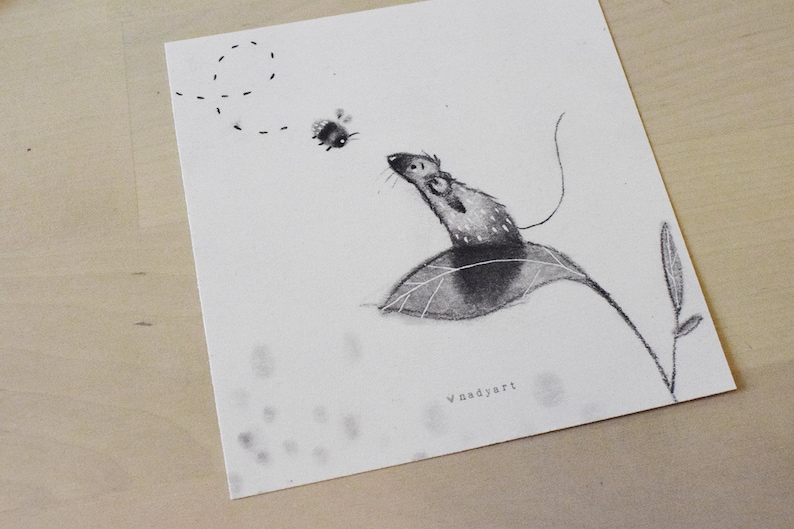 May include: A black and white drawing of a mouse sitting on a leaf, looking up at a bee flying in a circle above. The drawing is signed "Vnadyart" in the bottom right corner.