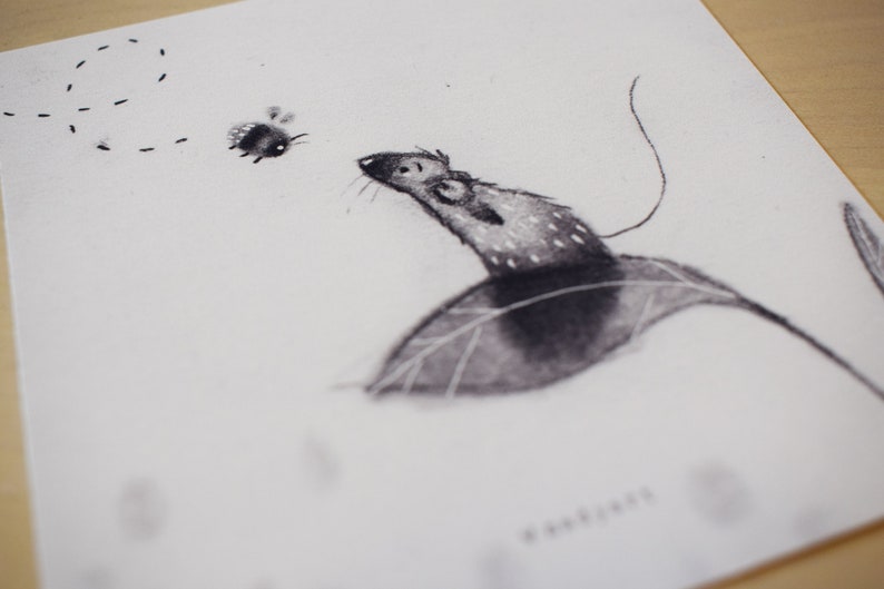 May include: A black and white drawing of a mouse sitting on a leaf, looking up at a small bee flying above. The drawing is on a white background.