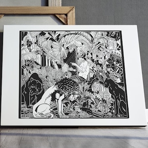 May include: Black and white art print featuring a detailed jungle scene with a lion, figures, and lush foliage. The artwork is framed in a white mat and displayed on a wooden surface, with a white desk lamp and a wooden frame in the background.