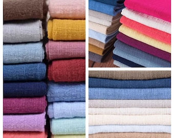May include: A collection of fabric swatches in various colors and textures, including brown, gray, yellow, pink, red, blue, white, and beige. The swatches are stacked neatly and arranged in a grid pattern.