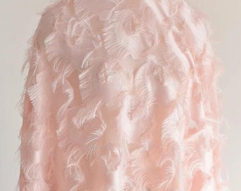 May include: A pale pink fabric with a textured, feathery design. The fabric has a soft, delicate look and feel.