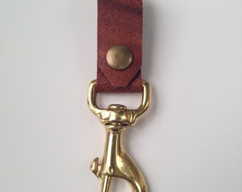 May include: A brown leather key chain with a brass swivel hook.