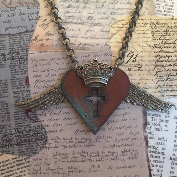 Steampunk heart, wing, crown and cross on an antique silver 22" necklace featuring a vintage heart w/ a cut out cross, wings & crown.