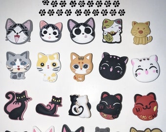May include: A collection of 18 colorful cat and black cat charms with various designs, including a cat with a crown, a cat with a heart, a cat with a fish, and a cat with a bell. The charms are made of a soft, rubbery material and are perfect for adding a touch of whimsy to your keychain, backpack, or phone case.