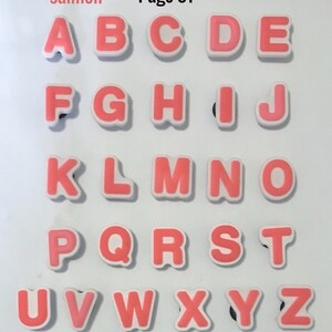 Puede incluir: Un conjunto de letras del alfabeto de color salm&oacute;n con bordes blancos. Las letras est&aacute;n dispuestas en filas y columnas, con el texto "salmon" y "Page 91" en la esquina superior izquierda.