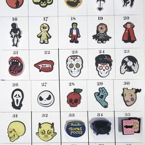 May include: A grid of fifty numbered Halloween-themed shoe charms featuring various designs including ghosts, pumpkins, skulls, witches, and monsters. Each charm is a small, colorful, molded figure with distinct icons like a Hocus Pocus cauldron.