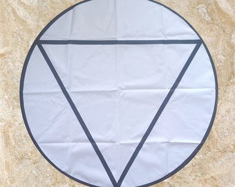 May include: A white round yoga mat with a black triangle design. The mat has a black border.