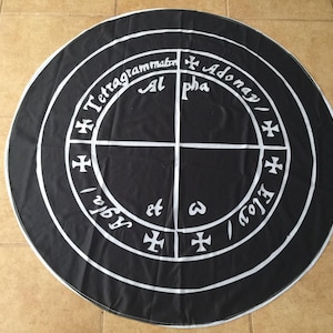 May include: A black circular cloth with white lettering and symbols. The text reads "Tetragrammaton Adonay/ Al pha" and "Agla/ Eloy/ 3".
