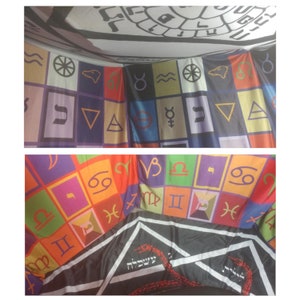 May include: A colorful fabric tapestry with a black and white design in the center. The tapestry features astrological symbols and Hebrew text. The tapestry is made of a soft, woven fabric.