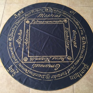 May include: A black circular cloth with gold lettering. The lettering includes the words "Messias", "Tetragrammaton", "Agla", "Alpha", "Adonay", "Elphubry", "Omega", "Dextra Domini", "Jesus Nazareth", "Emunnel", "Banthon", and "Deatra Domini".