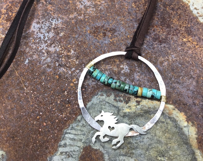 Running free rustic horse necklace with turquoise in center of large hammered sterling hoop, soft chocolate brown leather over head style