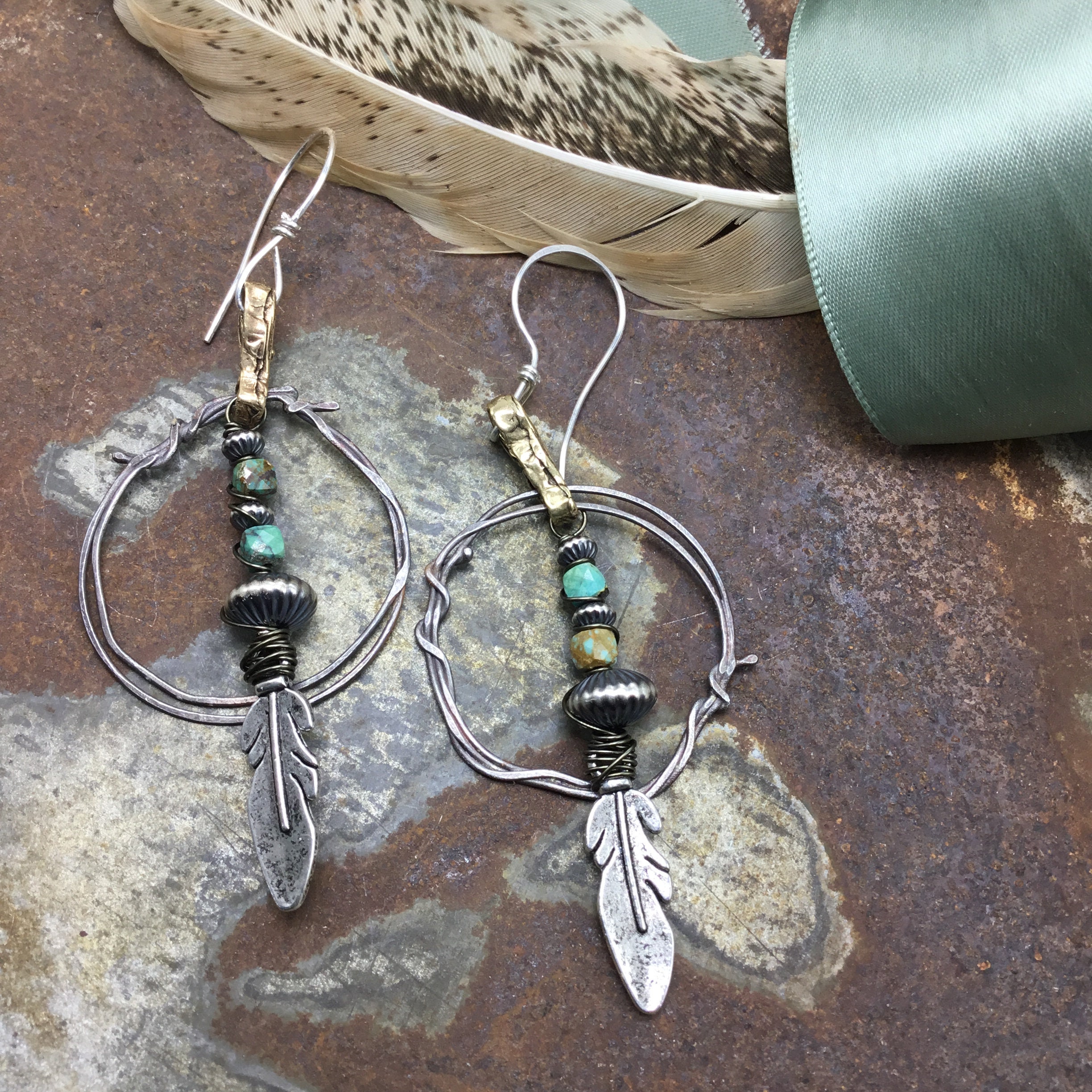 Super cool wire wrapped feather hoop earrings with rustic bronze and Sterling silver large statement hoops with a touch of turquoise