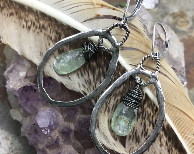 Soft green kyanite teardrop inside Sterling rustic hammered hoops with French clip Sterling ear wires by Weathered Soul jewelry