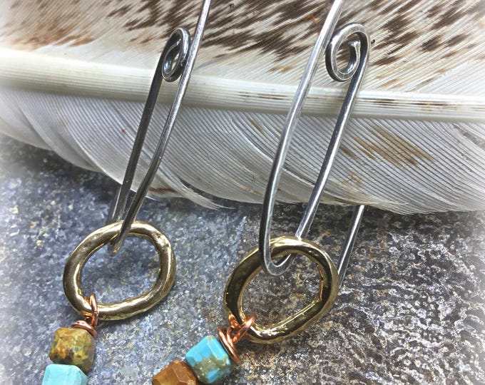 Itty bitty details are what you get with these tiny bronze hoops with swirl sterling ear wires, minimalist style with a lot of pizazz