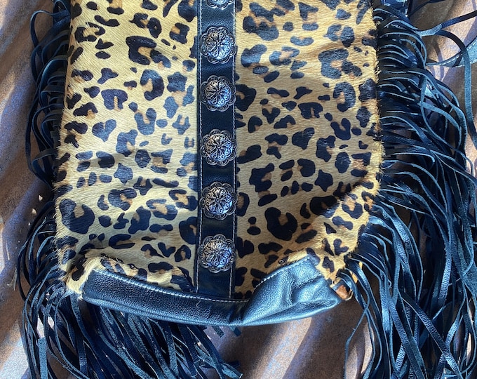 Sexy cheetah bag with long black fringe down each side adjustable crossbody strap plenty of room and pockets,get noticed boho western bag