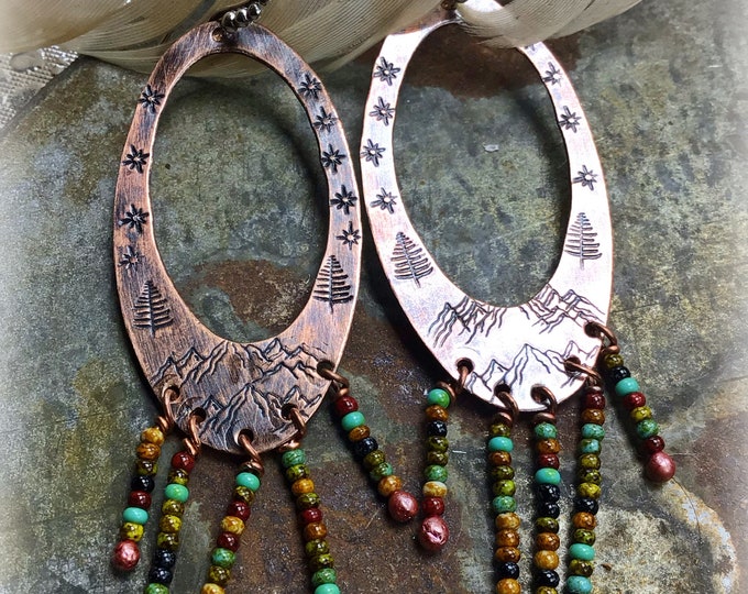 Mountains, stars, and trees embossed on these rustic oval beaded hoops with sterling ball ear wires