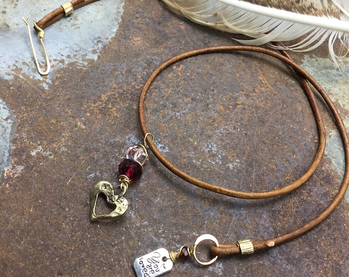 Sweet little bronze rustic heart with Greek leather cord and red and pink Swarovski crystals with garnet and a you are loved tag