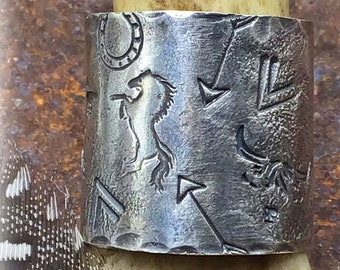 Wild West hand reticulated sterling silver wide band with horses highlander and miscellaneous western emblems. One of a kind