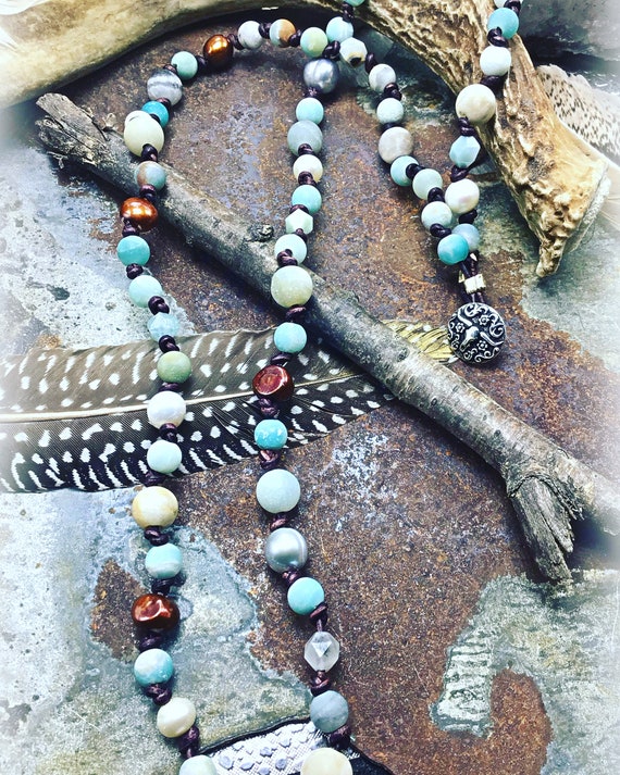 Amazonite , pearl,and leather make this either a very long beautiful necklace or a four time wrap around bracelet, longhorn button close