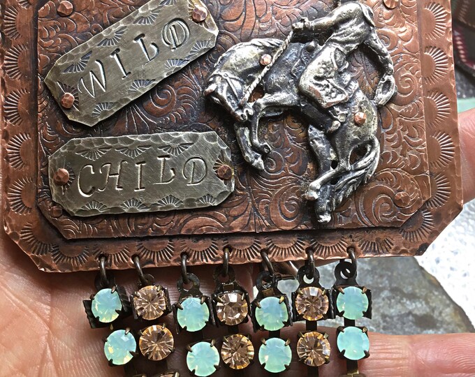 This is truly a one of a kind HUGE statement piece the size of a small belt buckle,Wild child bronc necklace by Weathered Soul,NFR fashion!