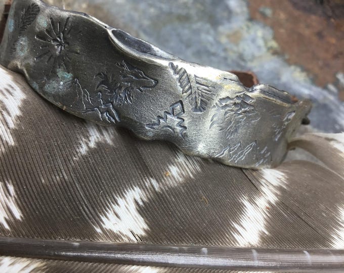 Very rustic reticulated sterling silver wolf,Aztec, and feather stamped bracelet with leather & buffalo nickel closure perfect rustic style