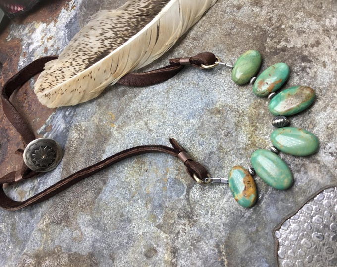 Genuine oval beautiful cut turquoise with western pearls leather and vintage concho button closure. Sits just below collarbone great length