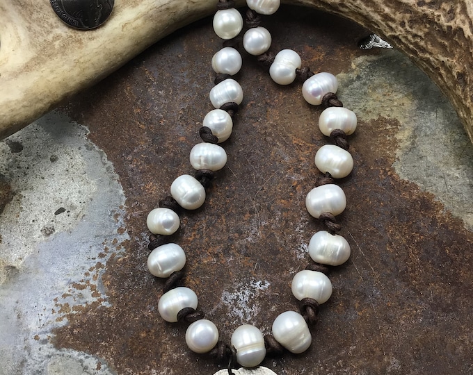 Buffalo and pearls necklace with a rustic elegance, soft Greek cord leather knotted between pearl, buffalo nickel button closure