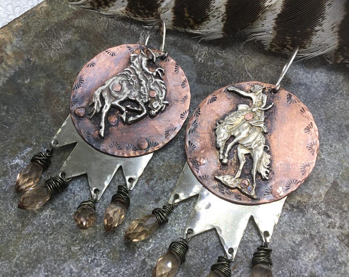Let them buck bronc earrings by Weathered Soul artisan out of the box cowgirl jewelry. Copper and sterling with champagne crystal drops
